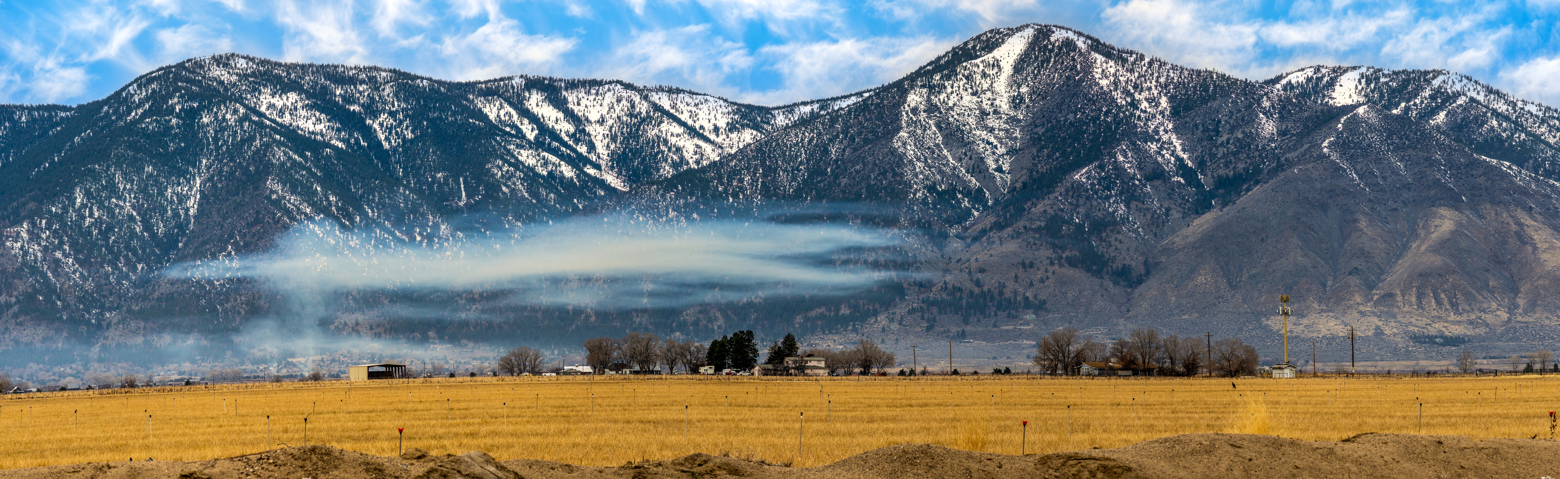 Snow-capped mountains above a ranch valley